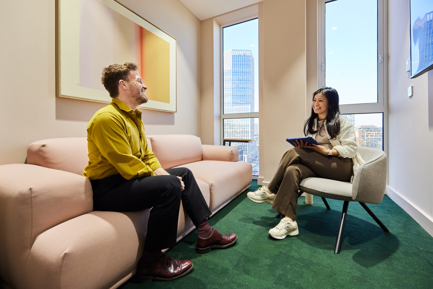 two people talking in a meeting room